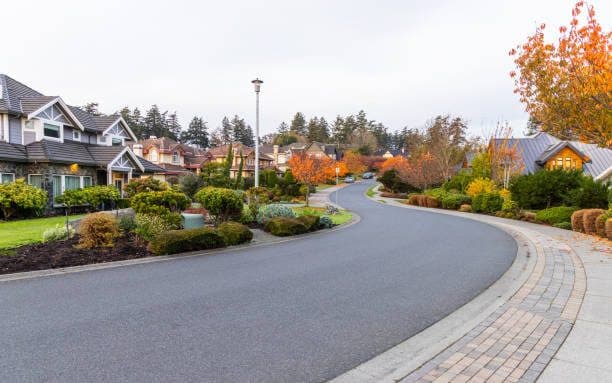 Tree-lined Victoria, BC neighborhood with well-kept home exteriors